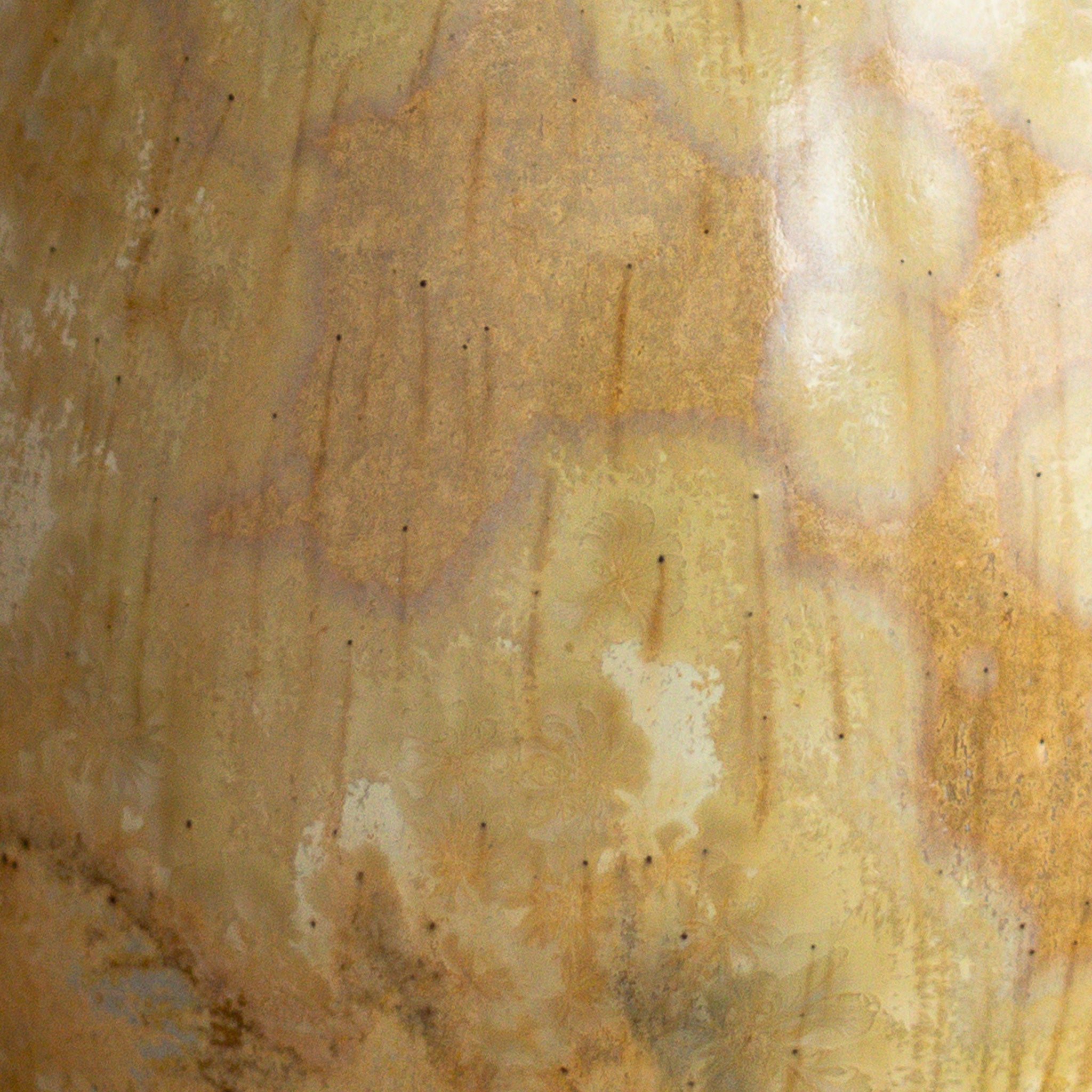 Close-up of a textured beige vase showing large fade crystals