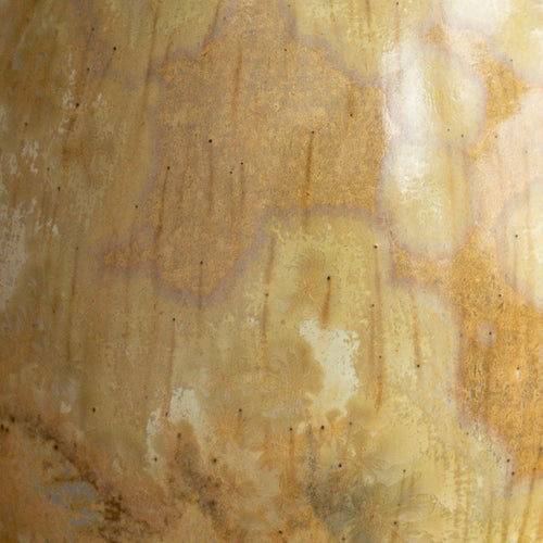 Close-up of a textured beige vase showing large fade crystals