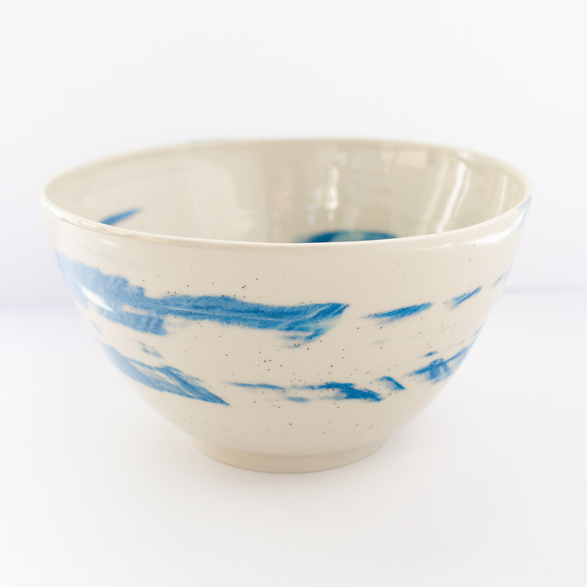 Ceramic bowl with blue abstract patterns on a white background