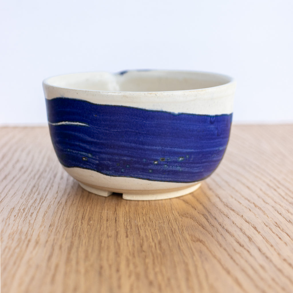 Ceramic bowl with blue and white design on a wooden surface
